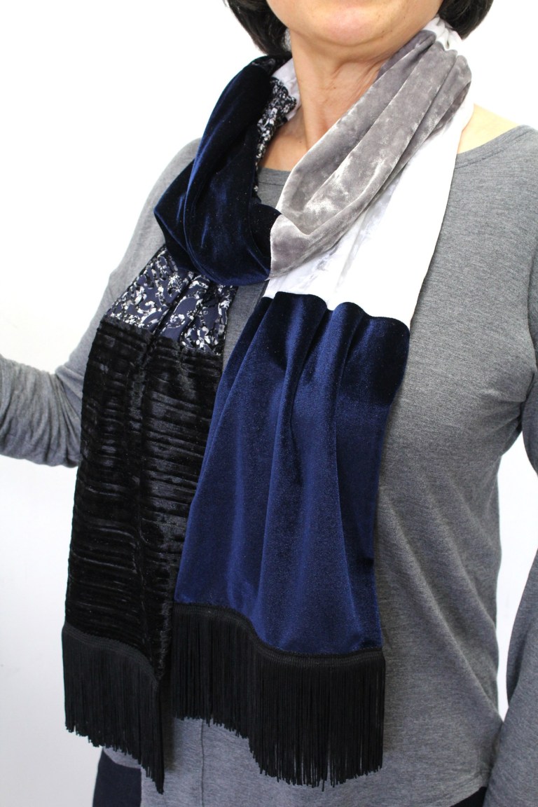 Model wearing a completed blue-black fringe scarf.