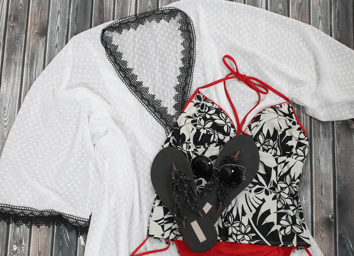 Closeup of summer outfit - completed kimono style cover up, swimsuit, flip flops & sunglasses
