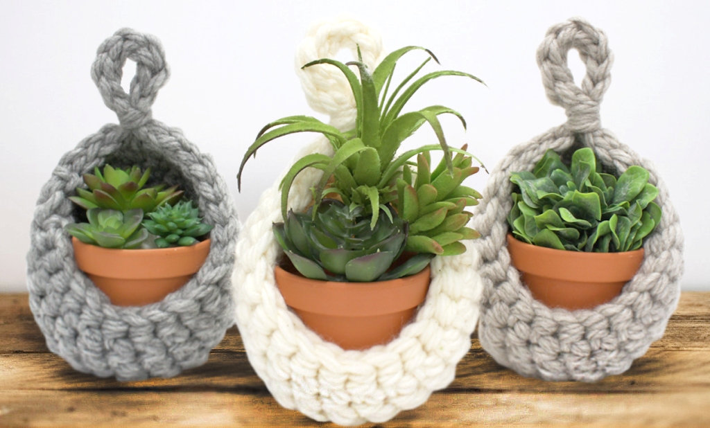 Closeup of three mini pot holders crocheted with grey & white weighted yarn